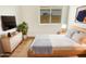 Bright bedroom featuring a modern dresser, television, decor, and natural light from a window at 4626 E Villa Rita Dr, Phoenix, AZ 85032