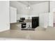 Bright kitchen features white cabinetry, black appliances and a stainless steel gooseneck faucet at 4626 E Villa Rita Dr, Phoenix, AZ 85032