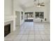 Open living room featuring tile flooring, fireplace, ceiling fan, and sliding glass doors to the backyard at 4626 E Villa Rita Dr, Phoenix, AZ 85032