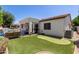 Relaxing backyard features a putting green and covered patio area, ideal for outdoor entertaining at 4706 E Des Moines St, Mesa, AZ 85205