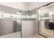 Modern bathroom showcasing dual shower heads, pebble flooring and decorative grey tile at 4706 E Des Moines St, Mesa, AZ 85205