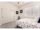 Comfortable bedroom featuring carpet, a floral designed bedspread and shuttered windows at 4706 E Des Moines St, Mesa, AZ 85205