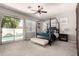 Primary bedroom with a four poster bed, plush carpeting, and sliding door access to the pool at 4706 E Des Moines St, Mesa, AZ 85205