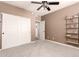 Bedroom features carpet, a ceiling fan, shelving, and a closet, perfect for a room at 4706 E Des Moines St, Mesa, AZ 85205