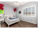 Cozy bedroom with wood flooring, plush bedding and a window with custom shutter coverings at 4706 E Des Moines St, Mesa, AZ 85205