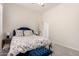 Comfortable bedroom features soft carpet, a floral patterned queen bed, and a blue upholstered headboard and footstool at 4706 E Des Moines St, Mesa, AZ 85205