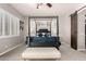 Primary bedroom featuring plush carpeting, a four poster bed and modern lighting at 4706 E Des Moines St, Mesa, AZ 85205
