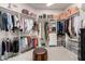 Walk-in closet with custom shelving, ample storage space, and a central ottoman at 4706 E Des Moines St, Mesa, AZ 85205