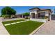 Inviting home exterior with manicured lawn, tile roof, and stylish stone accents at 4706 E Des Moines St, Mesa, AZ 85205