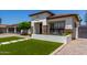Welcoming home featuring a tile roof, lush lawn, and charming curb appeal at 4706 E Des Moines St, Mesa, AZ 85205