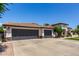 Beautiful home featuring a three-car garage, tile roof, and pristine front yard at 4706 E Des Moines St, Mesa, AZ 85205