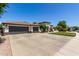 Spacious single-Gathering home featuring a three-car garage and beautiful landscaping on a sunny day at 4706 E Des Moines St, Mesa, AZ 85205