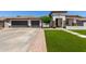 Charming single-story home with a three-car garage, well-manicured lawn and neutral color scheme at 4706 E Des Moines St, Mesa, AZ 85205
