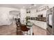 Open kitchen featuring a large island with seating, stainless steel appliances, and plenty of cabinet space at 4706 E Des Moines St, Mesa, AZ 85205