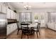 Charming kitchen nook with white cabinets, breakfast area, and tile backsplash at 4706 E Des Moines St, Mesa, AZ 85205