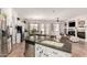 Open concept kitchen with granite counters, stainless appliances, and connection to the dining and living areas at 4706 E Des Moines St, Mesa, AZ 85205