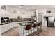 Bright kitchen featuring white cabinetry, granite countertops, island with seating, and stainless steel appliances at 4706 E Des Moines St, Mesa, AZ 85205