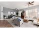 Spacious living room with neutral walls, plantation shutters, ceiling fan and comfortable seating at 4706 E Des Moines St, Mesa, AZ 85205