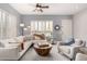 Serene living room featuring plantation shutters, ceiling fan, and soothing color palette at 4706 E Des Moines St, Mesa, AZ 85205