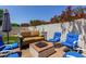 Inviting backyard patio with a brick fire pit and comfortable seating arrangement, great for gatherings and relaxation at 4706 E Des Moines St, Mesa, AZ 85205