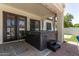 Covered patio featuring a luxurious hot tub with a step stool, and easy access to the house via double doors at 4706 E Des Moines St, Mesa, AZ 85205