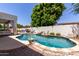 Sparkling backyard pool surrounded by lush greenery and patio furniture, ideal for summer fun and relaxation at 4706 E Des Moines St, Mesa, AZ 85205