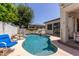 Backyard swimming pool with rock features and lush landscaping, perfect for relaxation and outdoor enjoyment at 4706 E Des Moines St, Mesa, AZ 85205