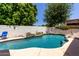Private backyard pool with waterfall feature and lush landscaping for relaxing outdoor living at 4706 E Des Moines St, Mesa, AZ 85205
