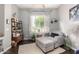 Comfortable sitting area with a gray chaise lounge, stylish decor, and ample natural light streaming through the windows at 4706 E Des Moines St, Mesa, AZ 85205