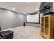 Home theater room features tile flooring, a blank screen, comfortable seating and an entertainment center at 4706 E Des Moines St, Mesa, AZ 85205