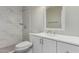 Bathroom features a tiled stand-up shower, white vanity, framed mirror and modern finishes at 4750 N 50Th Ave, Phoenix, AZ 85031