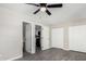 Open bedroom with vinyl floors and ceiling fan leads to ensuite bathroom and renovated kitchen at 4750 N 50Th Ave, Phoenix, AZ 85031
