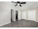 Spacious bedroom features hardwood-style flooring, ceiling fan, and doorways to bathroom and kitchen at 4750 N 50Th Ave, Phoenix, AZ 85031