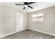 Bright bedroom featuring wood-style flooring, ceiling fan, and a sunny window view at 4750 N 50Th Ave, Phoenix, AZ 85031