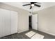 This bedroom features a ceiling fan, wood-look flooring, and a double-door closet at 4750 N 50Th Ave, Phoenix, AZ 85031