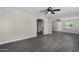 Spacious living room features wood-look floors and is open to the dining and Gathering areas at 4750 N 50Th Ave, Phoenix, AZ 85031