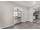 Open-concept living space with wood-style floors flows into kitchen through an arched doorway at 4750 N 50Th Ave, Phoenix, AZ 85031