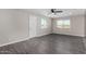 Bright living room features wood-style flooring, modern ceiling fan and natural light from double-pane windows at 4750 N 50Th Ave, Phoenix, AZ 85031