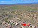 Expansive aerial view of desert community, with golf course, single Gathering homes, mountain views and beautiful blue sky at 5049 E Duane Ln, Cave Creek, AZ 85331
