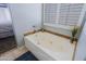 Soaking tub with tiled backdrop and plantation shutters in the Primary bathroom at 5049 E Duane Ln, Cave Creek, AZ 85331
