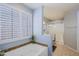 Bright bathroom featuring a soaking tub with tile surround and plantation shutters at 5049 E Duane Ln, Cave Creek, AZ 85331