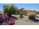 Beautiful home showcasing desert landscaping, a vibrant purple cactus, and mature shade trees at 5049 E Duane Ln, Cave Creek, AZ 85331