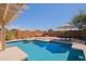 Beautiful backyard oasis with a pool, fireplace, seating, and outdoor dining area at 5049 E Duane Ln, Cave Creek, AZ 85331