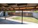 Expansive backyard featuring a covered patio, green space, and a sturdy wooden fence at 5229 W Palo Verde Ave, Glendale, AZ 85302