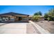 Exterior shot of home with long driveway and carport, perfect for parking at 5229 W Palo Verde Ave, Glendale, AZ 85302
