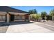 Home exterior featuring a carport, grass, and landscaped yard at 5229 W Palo Verde Ave, Glendale, AZ 85302