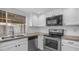 Bright kitchen features stainless steel appliances, granite countertops, and a double basin sink at 5229 W Palo Verde Ave, Glendale, AZ 85302