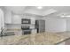 Open kitchen showcases granite counters, stainless appliances, and a breakfast bar for easy dining at 5229 W Palo Verde Ave, Glendale, AZ 85302