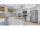 Well-lit kitchen boasts stainless appliances, granite counters, and a convenient breakfast bar at 5229 W Palo Verde Ave, Glendale, AZ 85302