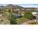 Aerial view of the house showing the expansive lawn, mountain views, and outdoor living area at 5339 E Osborn Rd, Phoenix, AZ 85018